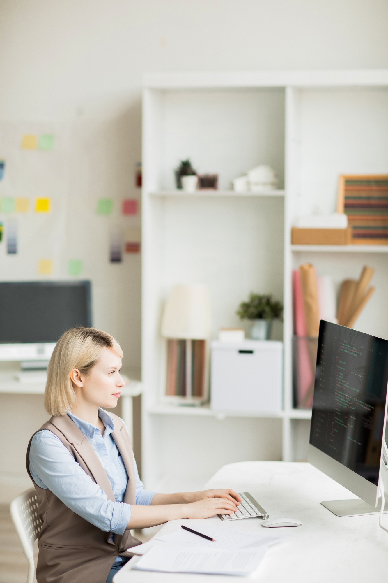 Concentrated woman coding information on computer